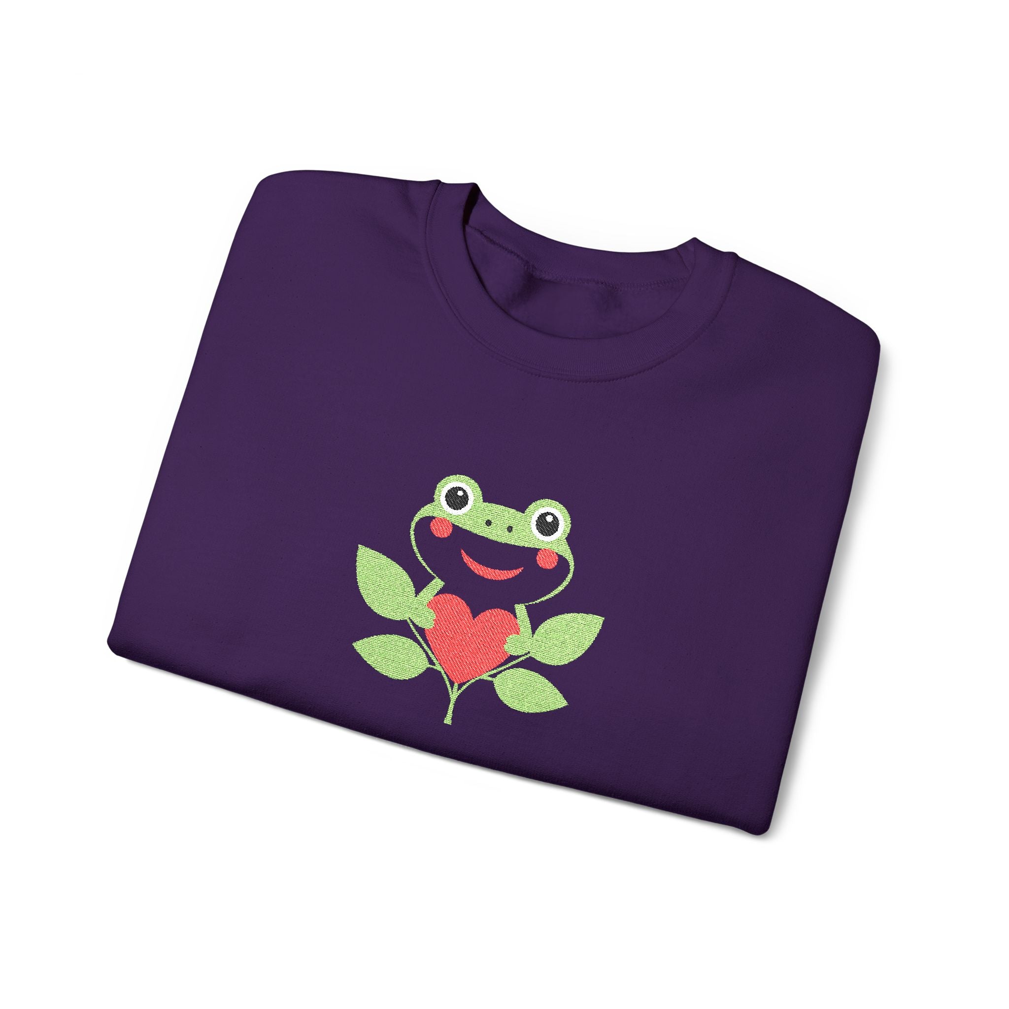 Folded purple shirt with a frog and heart design on a white background