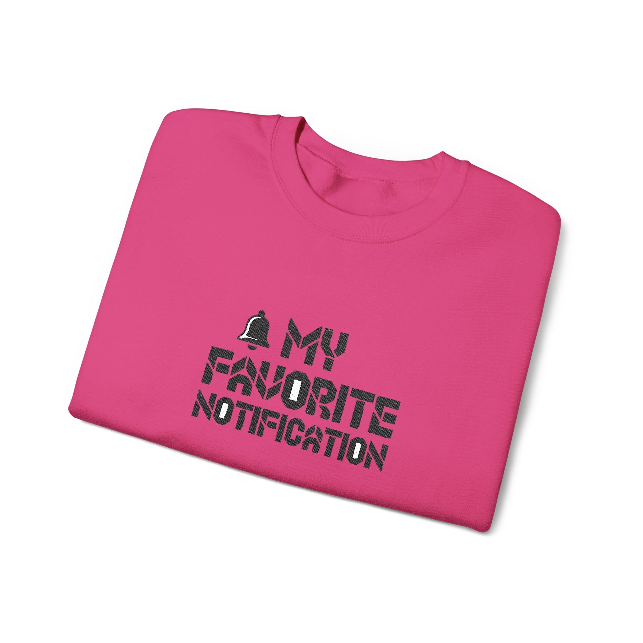 Folded pink t-shirt with black text on a white background