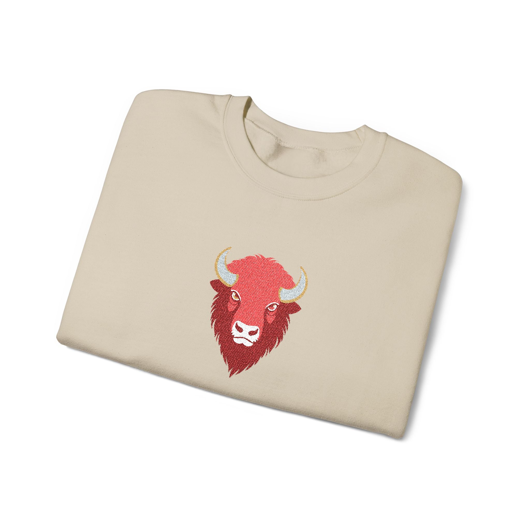 Folded beige sweatshirt with a red bull logo on a white background