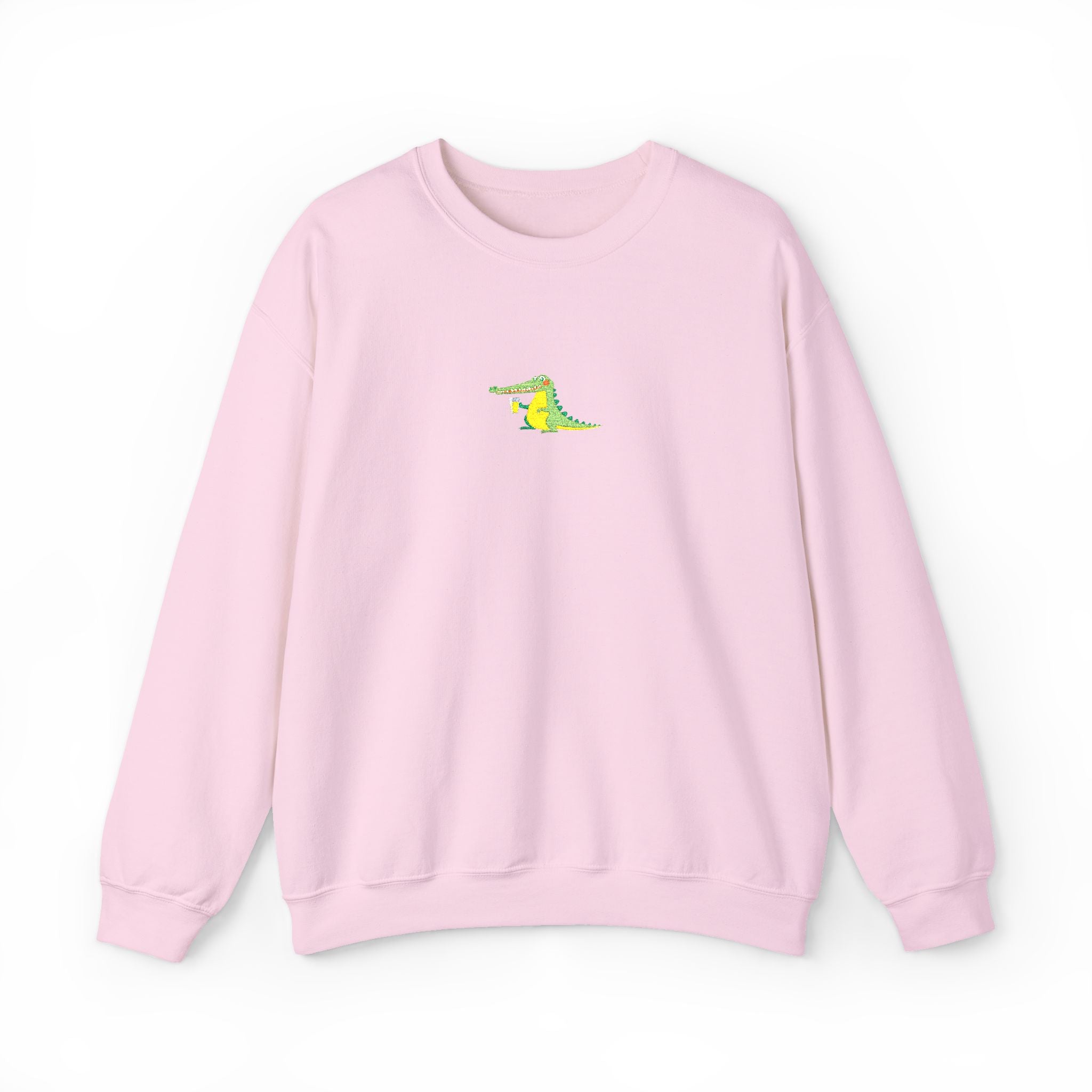 Pink sweatshirt with a small green and yellow graphic on a white background