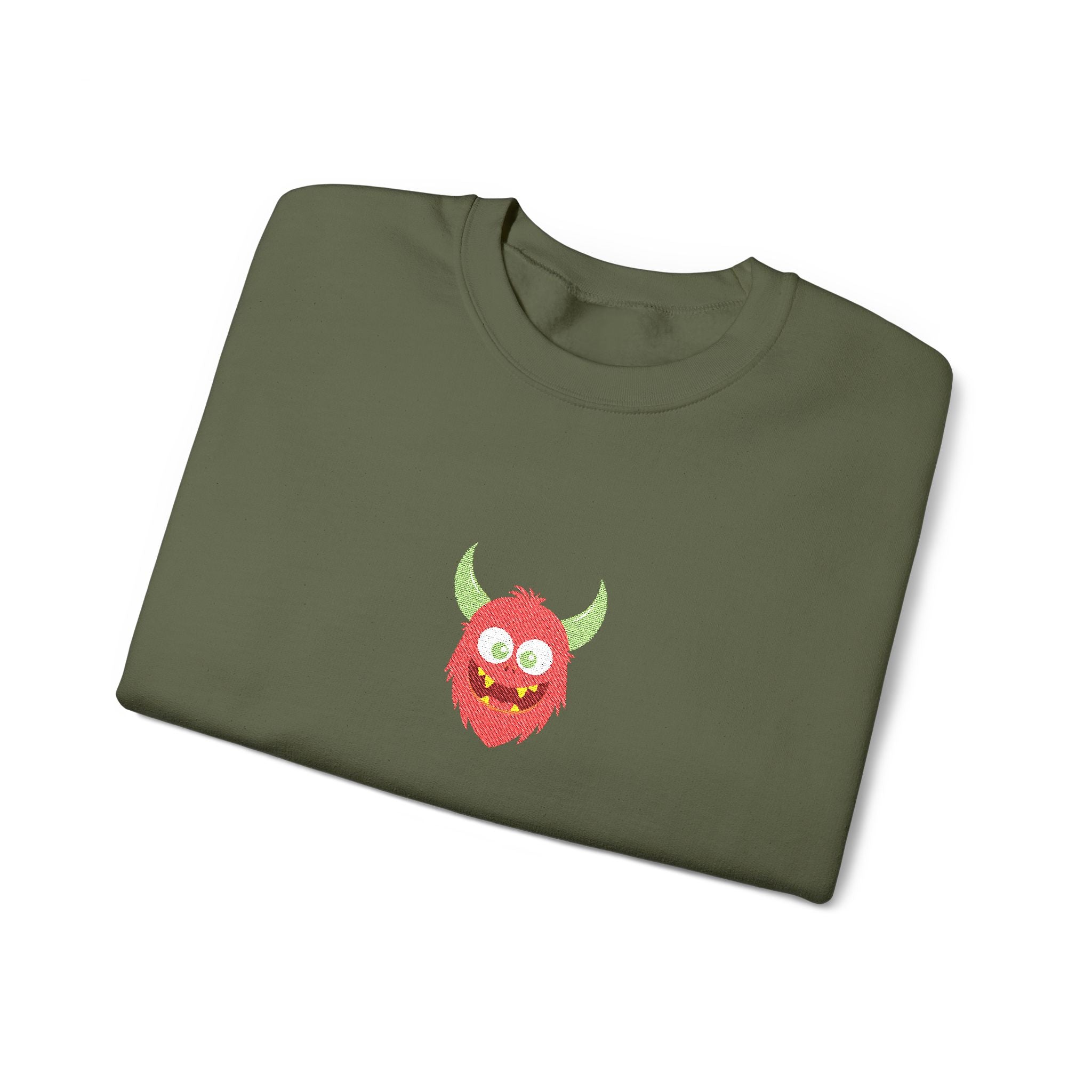 Folded green sweatshirt with a red monster design on a white background