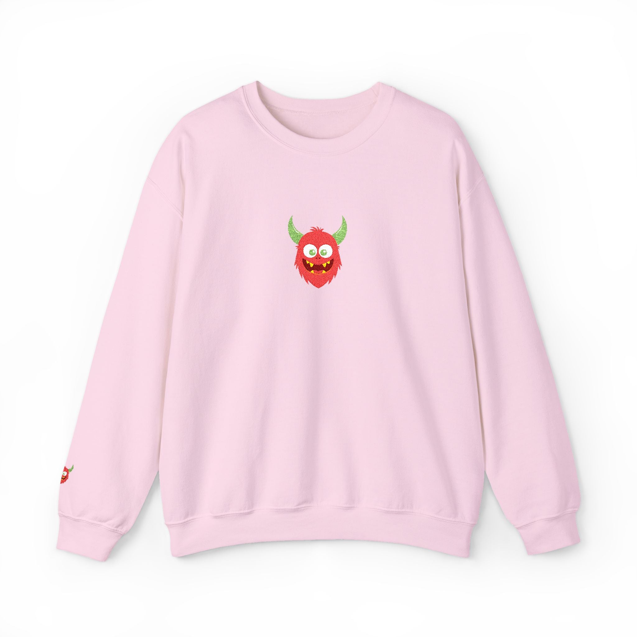 Pink sweatshirt with a red monster graphic on a white background