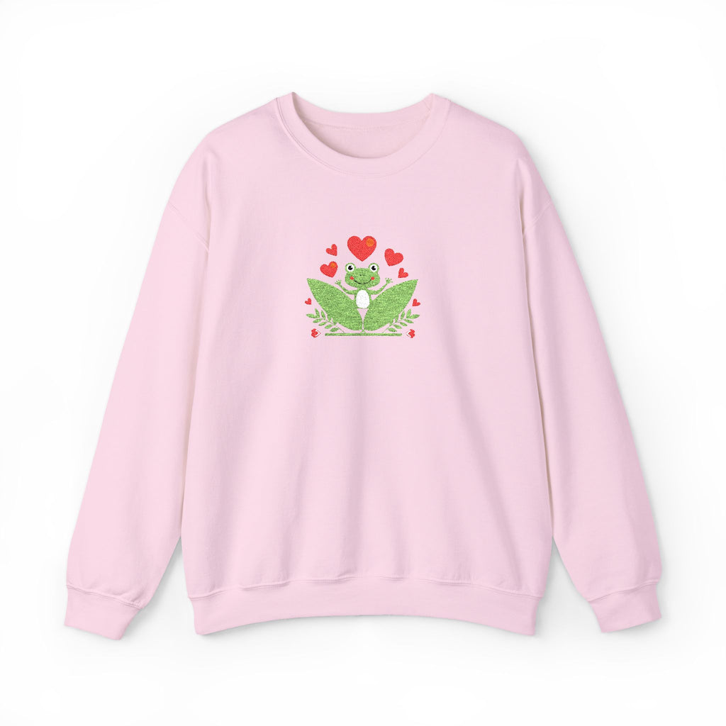 Pink sweatshirt with a green frog and red hearts design on a white background