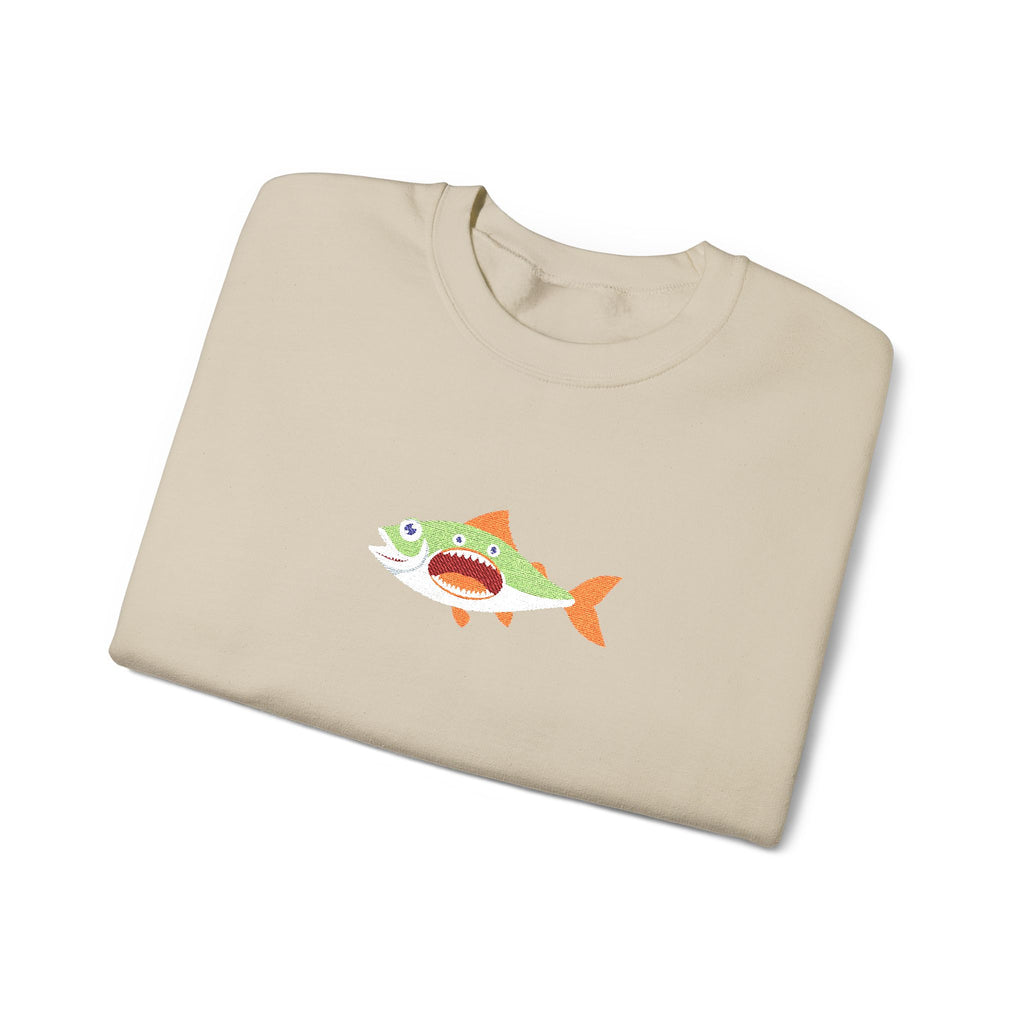 Folded beige t-shirt with a fish graphic on a white background