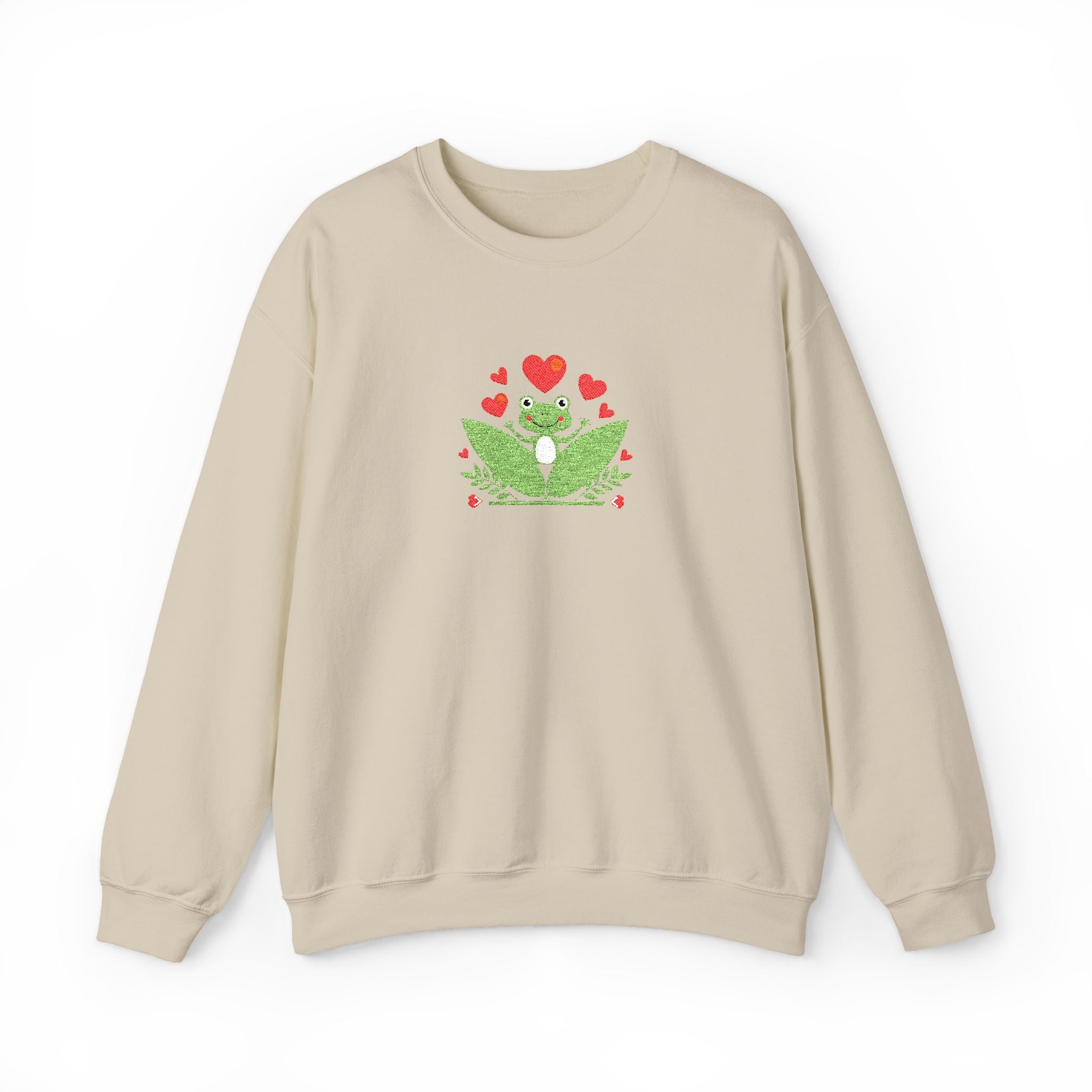 Beige sweatshirt with a green frog design and red hearts on a white background