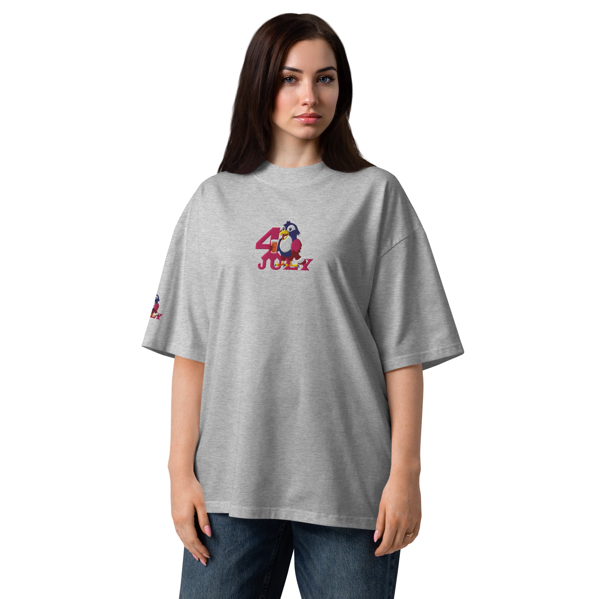 Woman wearing a gray t-shirt with a green and red design on a white background