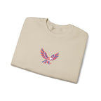 Folded beige sweatshirt with a colorful eagle design on a white background