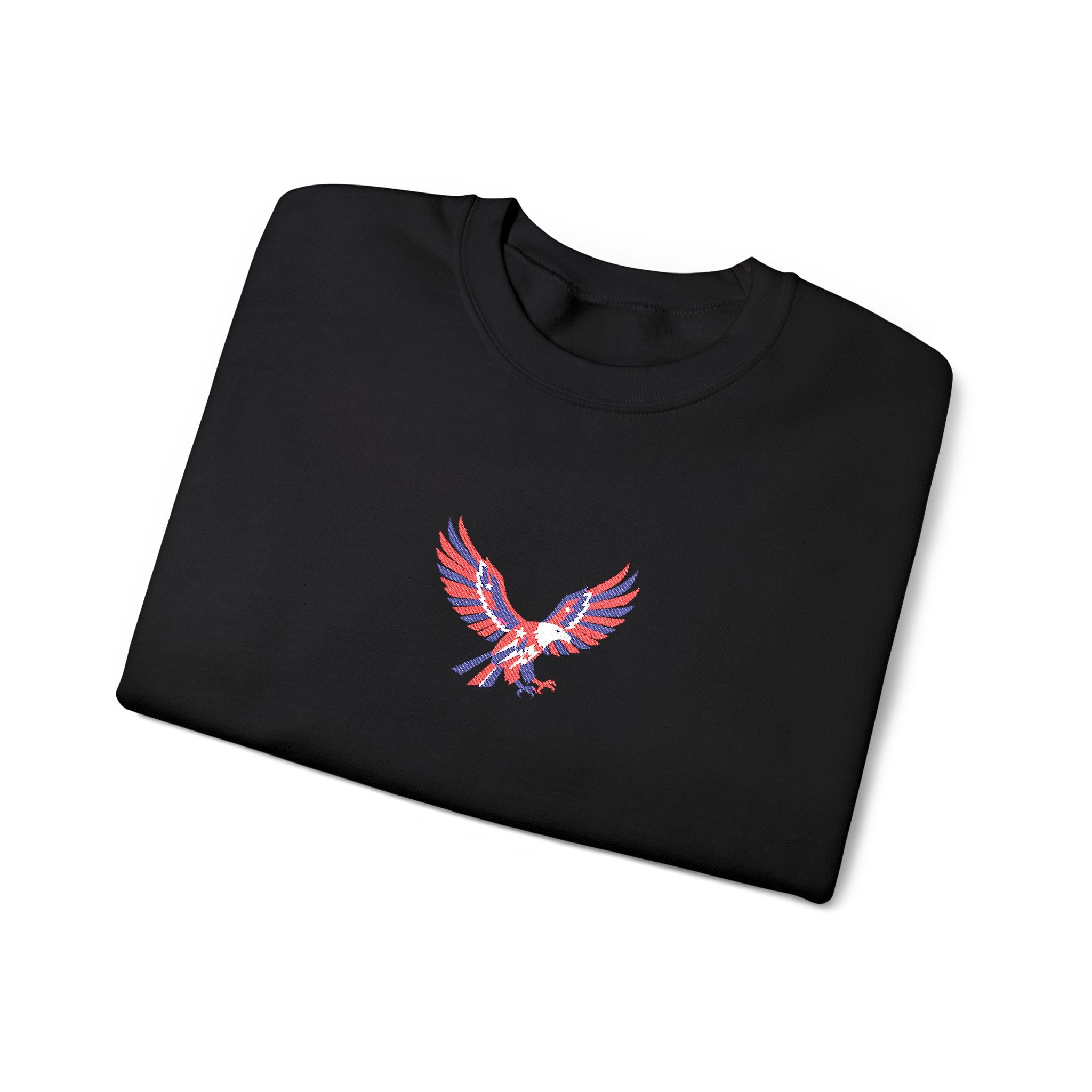 Folded black sweatshirt with a colorful eagle emblem on a white background