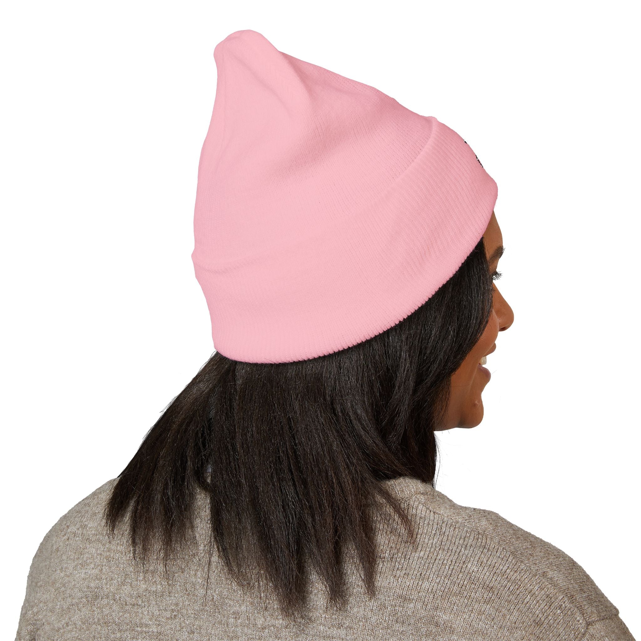 Person wearing a pink beanie on a white background