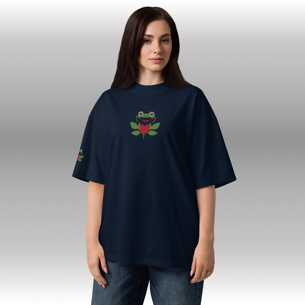 Person wearing a navy blue t-shirt with a frog design on a plain background