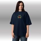 Person wearing a navy blue t-shirt with a frog design on a plain background