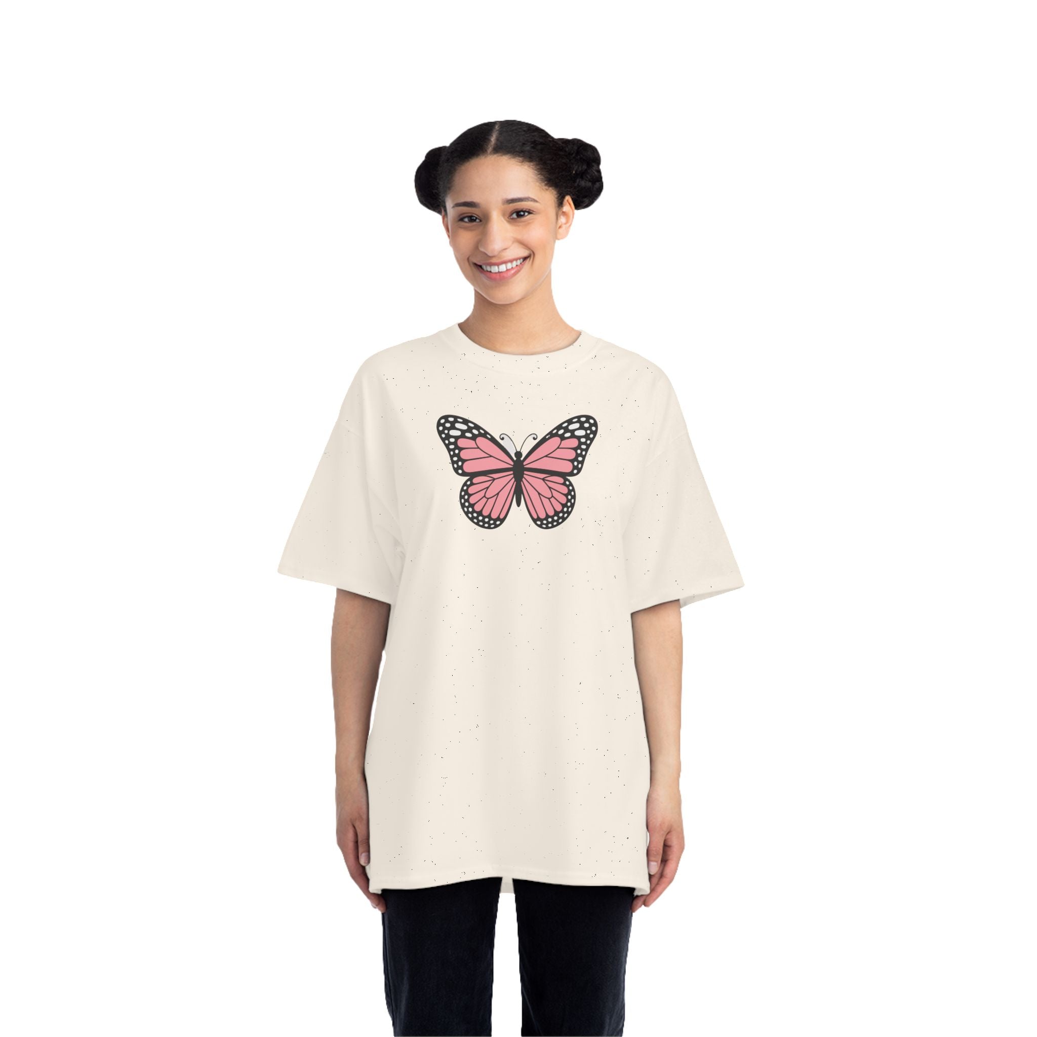 Person wearing a cream t-shirt with a pink butterfly design on a white background