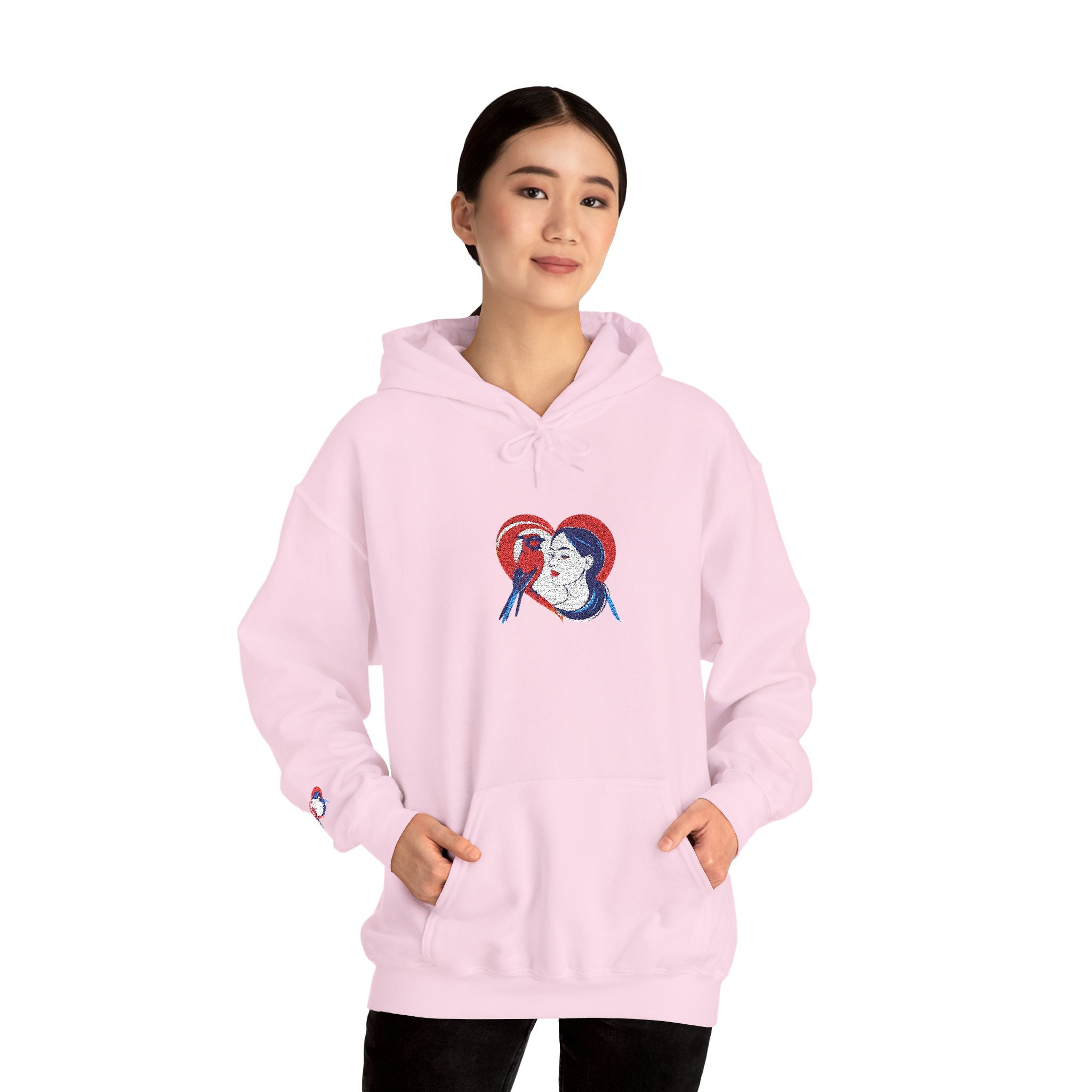 Person wearing a pink hoodie with a graphic design on a white background