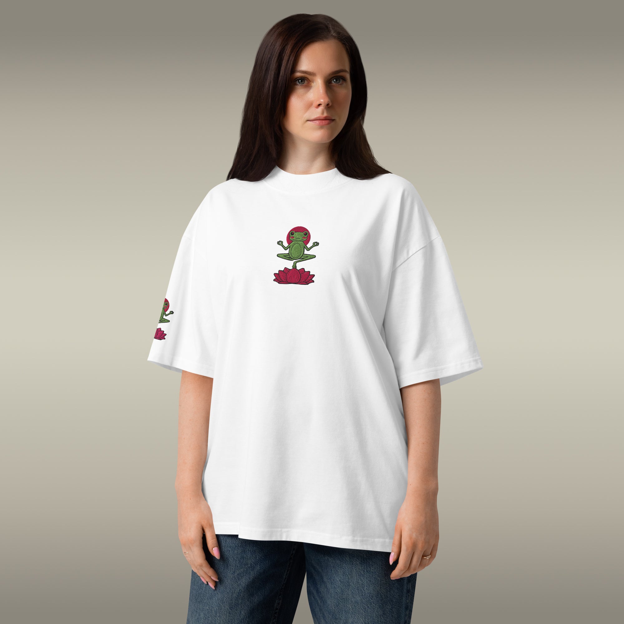 Person wearing a white t-shirt with a graphic design on a plain background