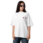 Woman wearing a white oversized t-shirt with heart designs on a white background