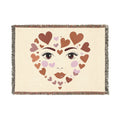 Blanket with heart design forming a face on a beige background