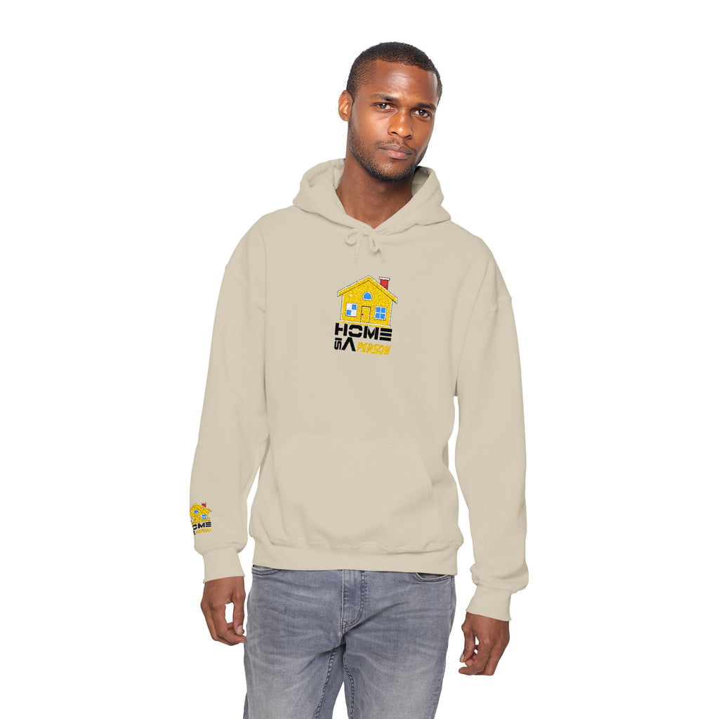 Man wearing a beige hoodie with a logo on a white background