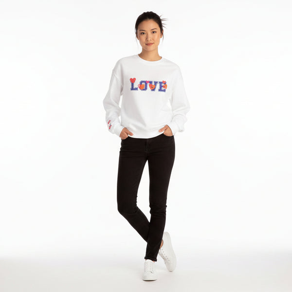 Person wearing a white sweatshirt with colorful 'LOVE' design on a white background