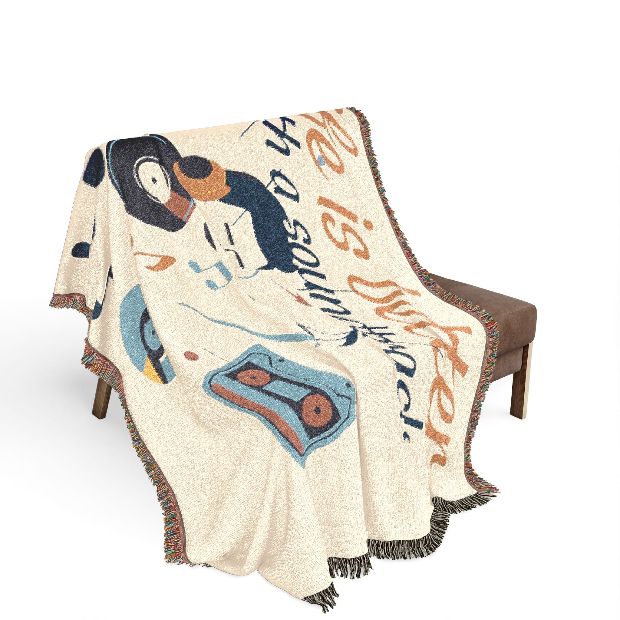 Decorative throw blanket with cartoon design draped over a chair on a white background