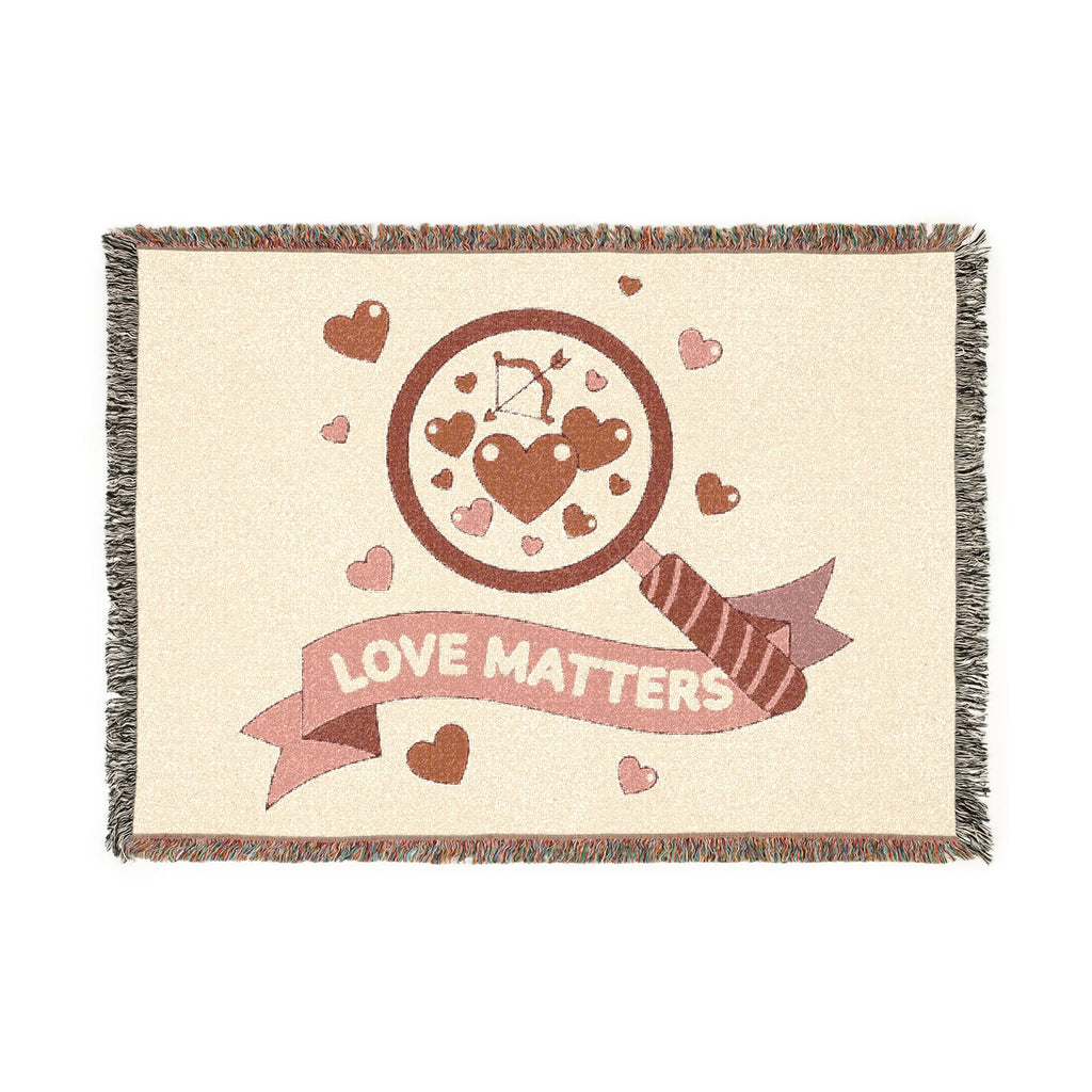 Blanket with 'Love Matters' design featuring hearts and an arrow on a beige background