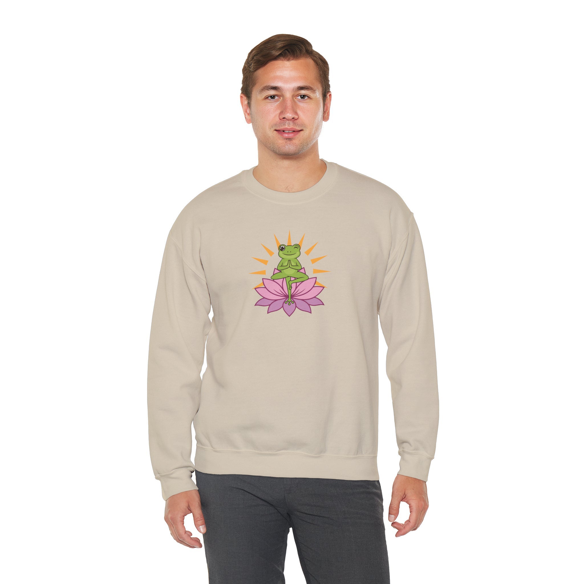 Man wearing a beige sweatshirt with a frog and flower graphic on a white background