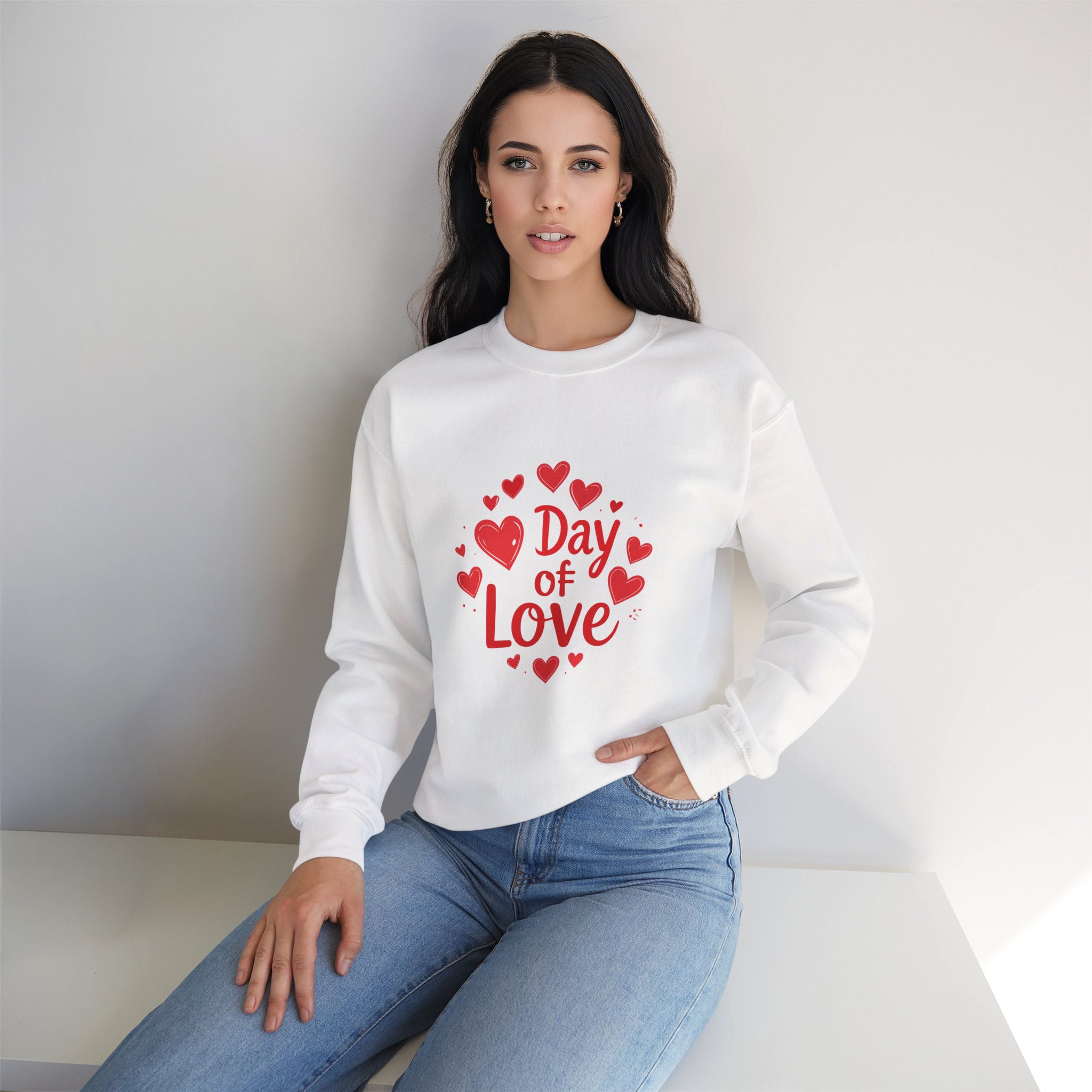 Woman wearing a white sweatshirt with 'Day of Love' text and red hearts on a plain background
