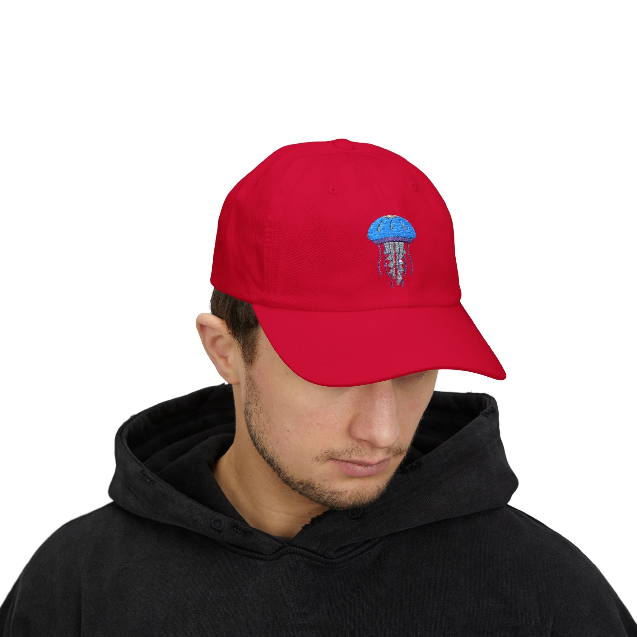 Person wearing a red cap with a blue and white design on a white background