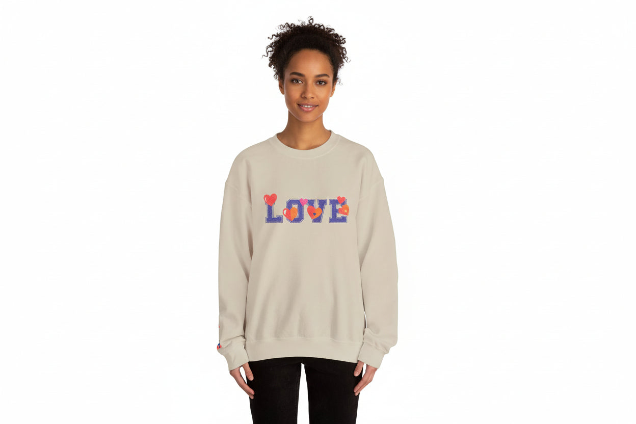 Person wearing a beige sweatshirt with colorful 'LOVE' text on a white background