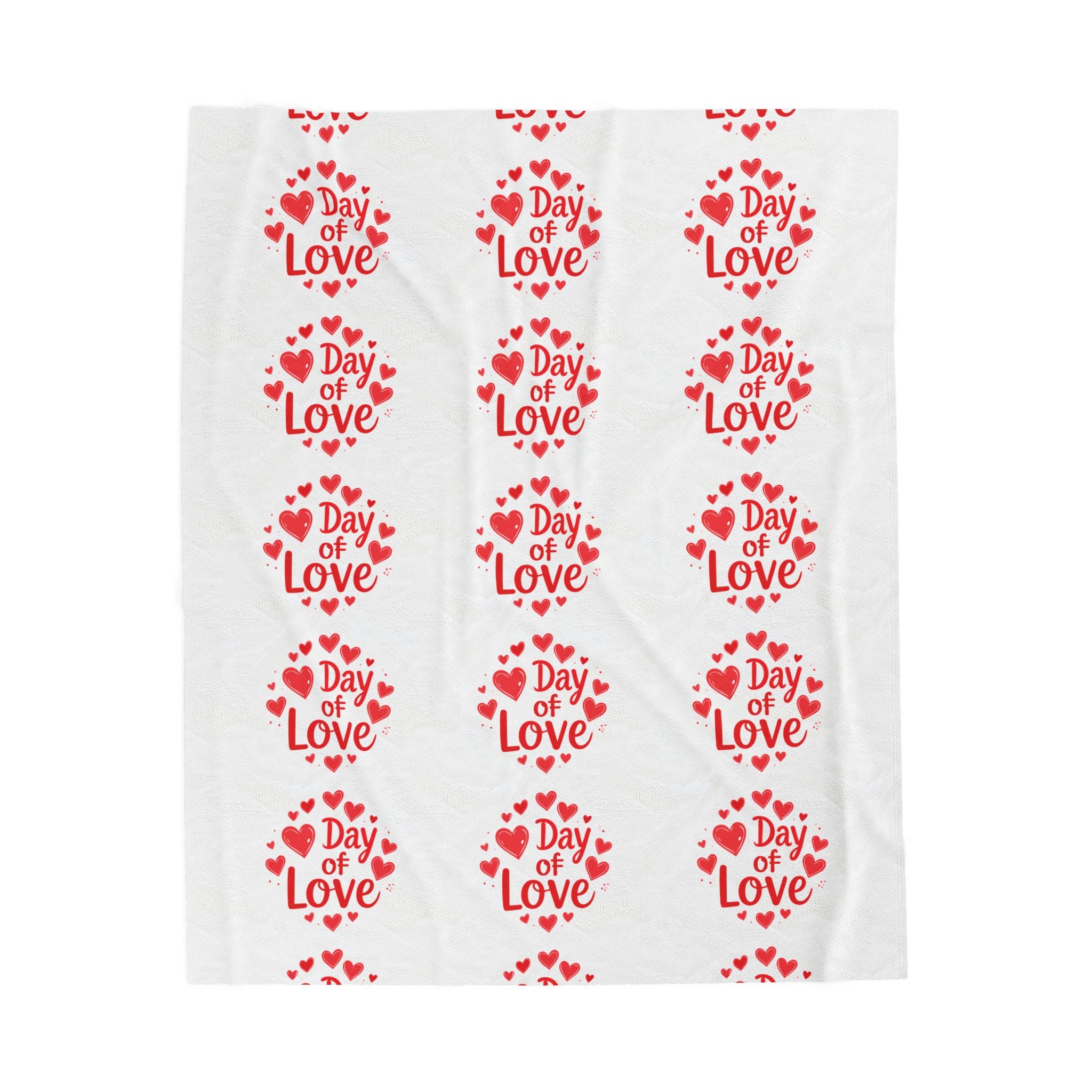 White towel with red 'Day of Love' text and heart patterns on a white background