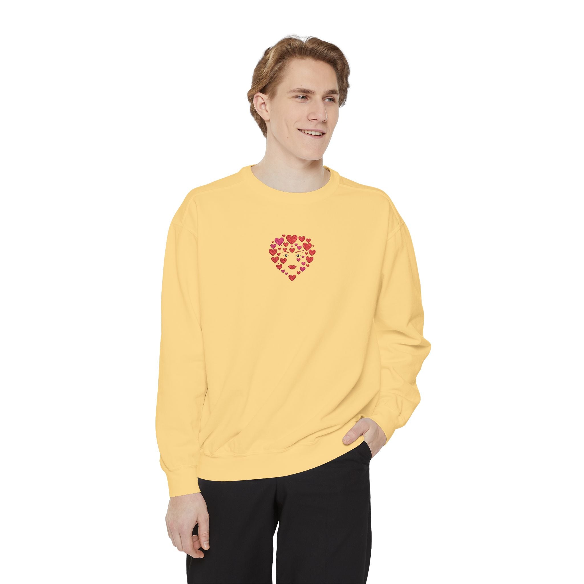 Person wearing a yellow sweatshirt with a heart design on a white background