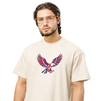Man wearing a beige t-shirt with an eagle graphic design on a white background