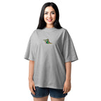 Woman wearing a gray oversized t-shirt with a colorful graphic on a white background