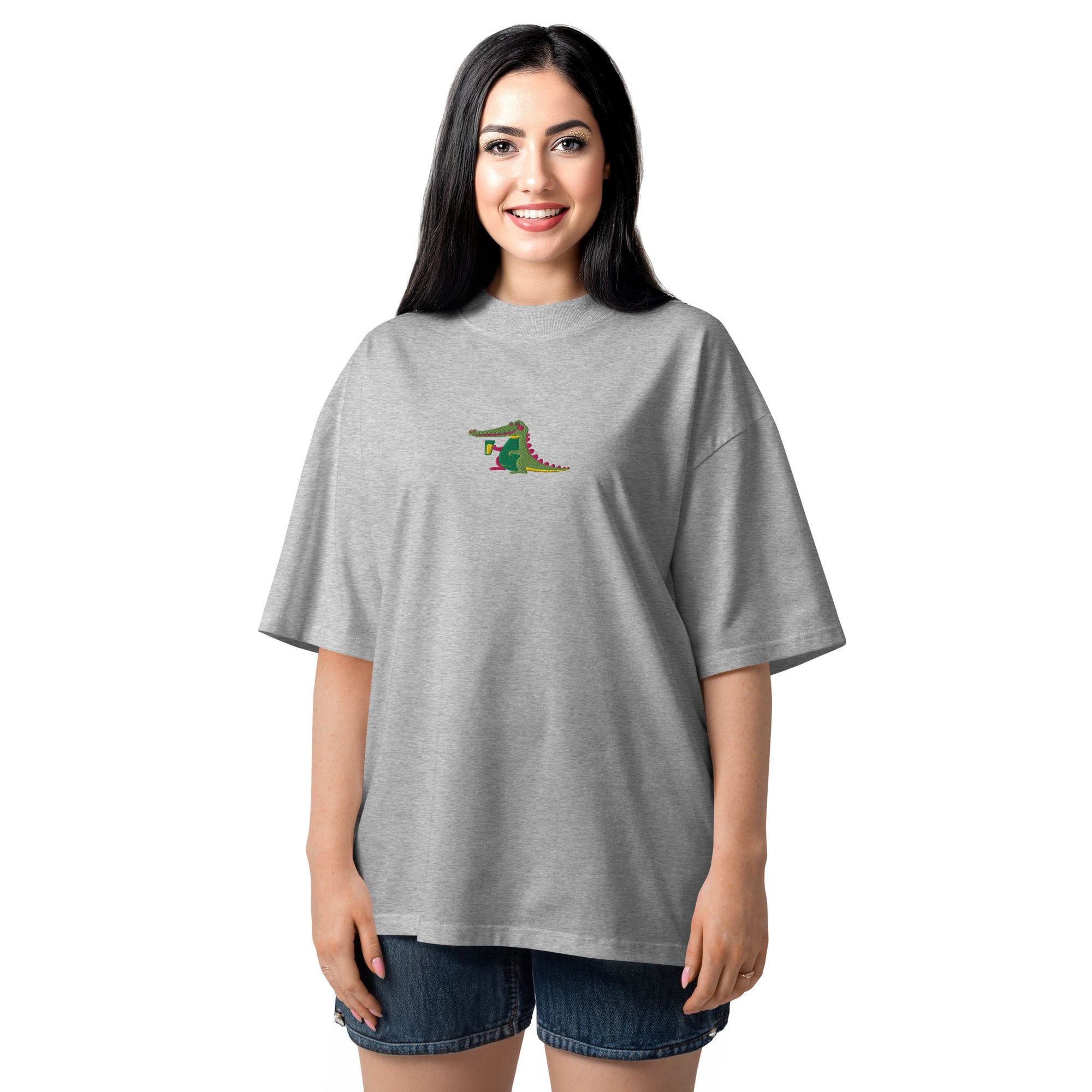 Woman wearing a gray oversized t-shirt with a colorful graphic on a white background