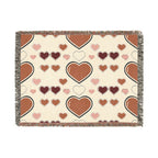 Heart-patterned blanket with brown and pink hearts on a beige background