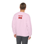 Person wearing a pink sweatshirt with cherry design on the back, on a white background