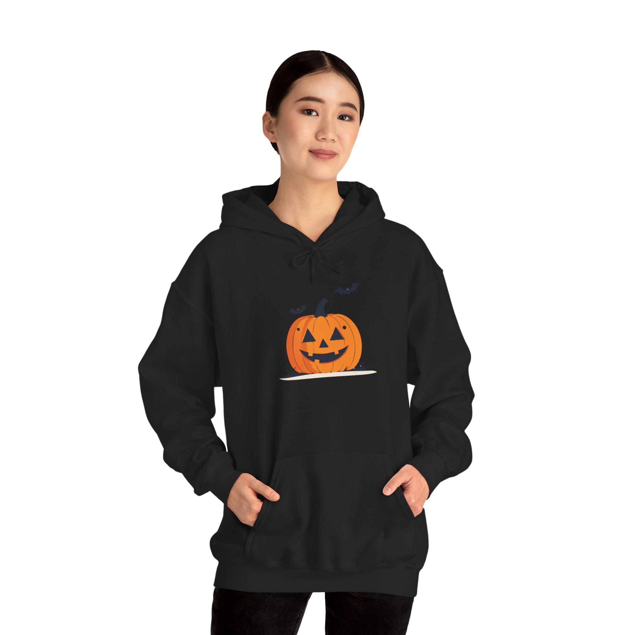 Person wearing a black hoodie with a pumpkin design on a white background
