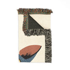 Textile with abstract design and fringed edges on a white background