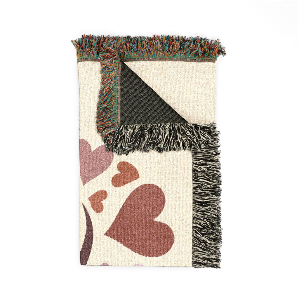 Blanket with heart patterns and fringed edges on a white background