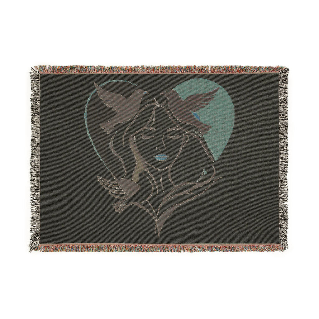 Blanket with a design of a woman's face and birds in a heart shape on a black background