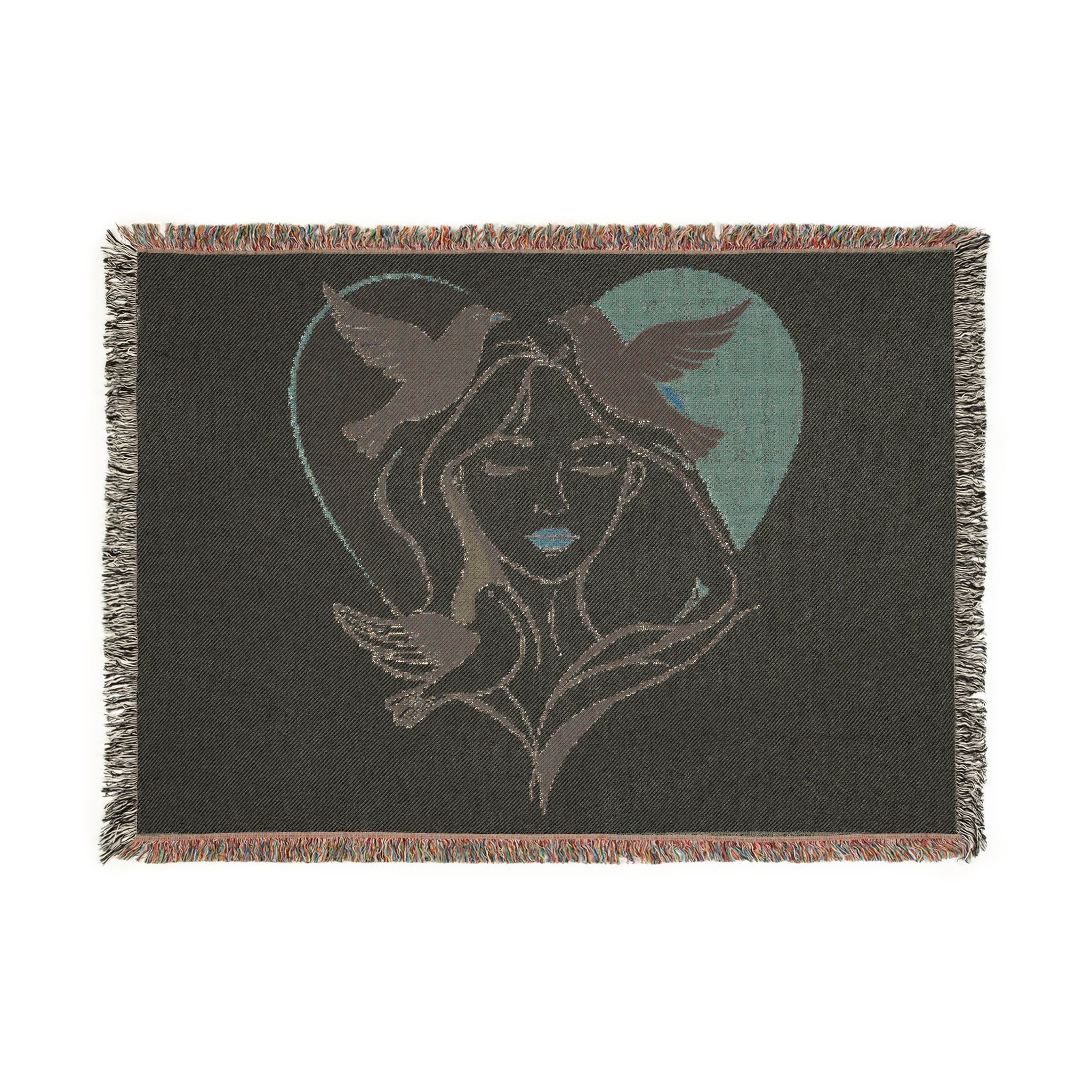 Blanket with a design of a woman's face and birds in a heart shape on a black background
