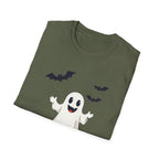 Folded green t-shirt with Halloween-themed design of a ghost, bats, and a moon on a white background.