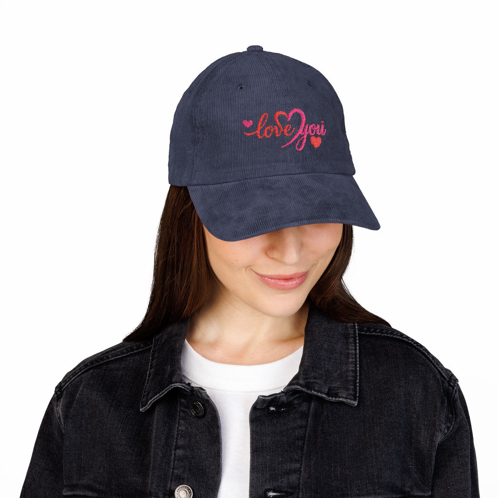 Person wearing a navy blue cap with a logo on a white background