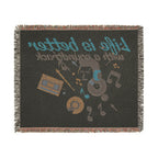 Blanket with music-themed design featuring cassette tape, vinyl record, and text on a black background.
