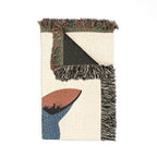 Textile with geometric pattern and fringes on a white background