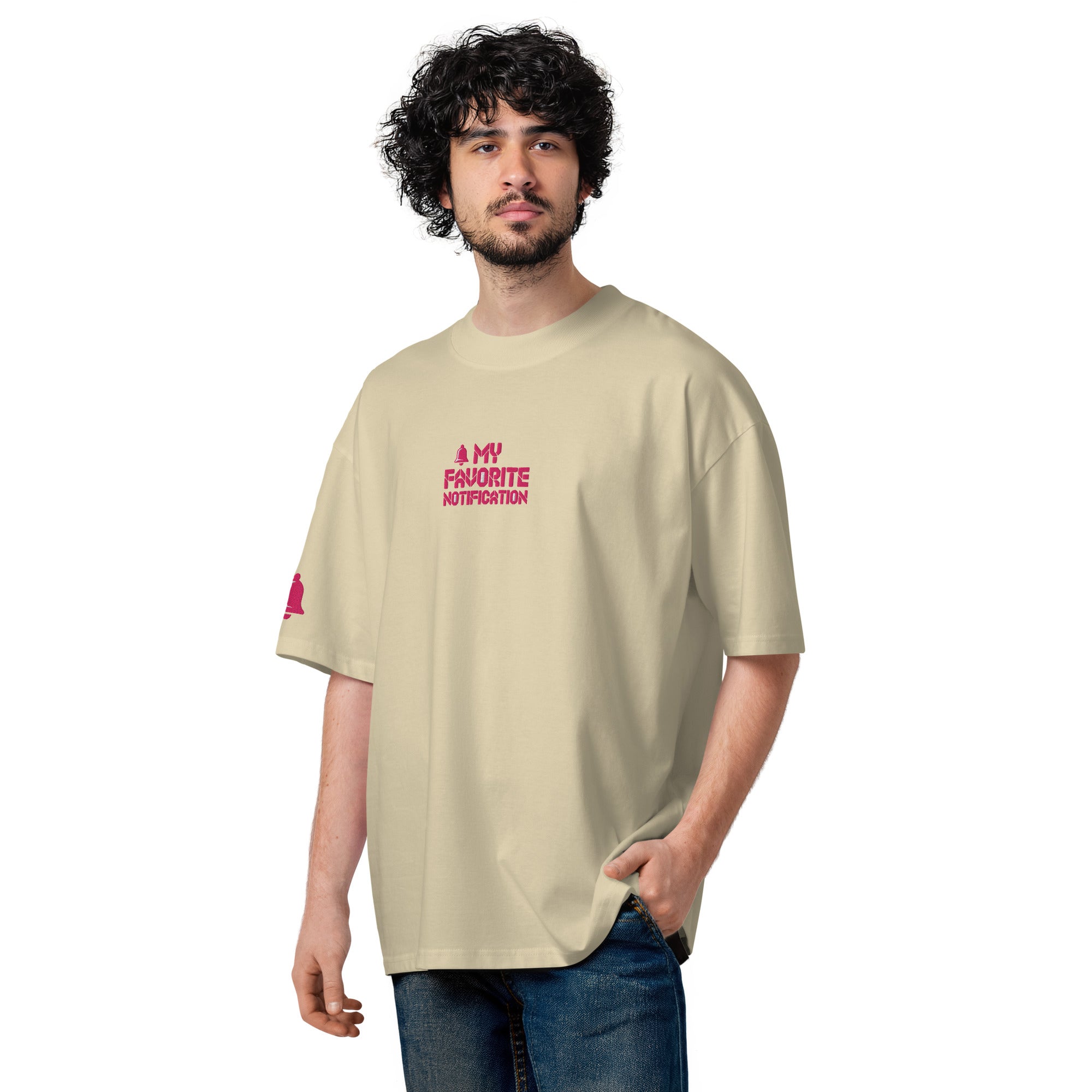Man wearing a beige t-shirt with pink text on a white background