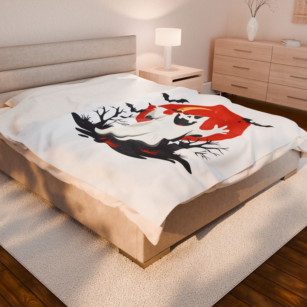 Bed with a decorative blanket featuring abstract art in a bedroom setting