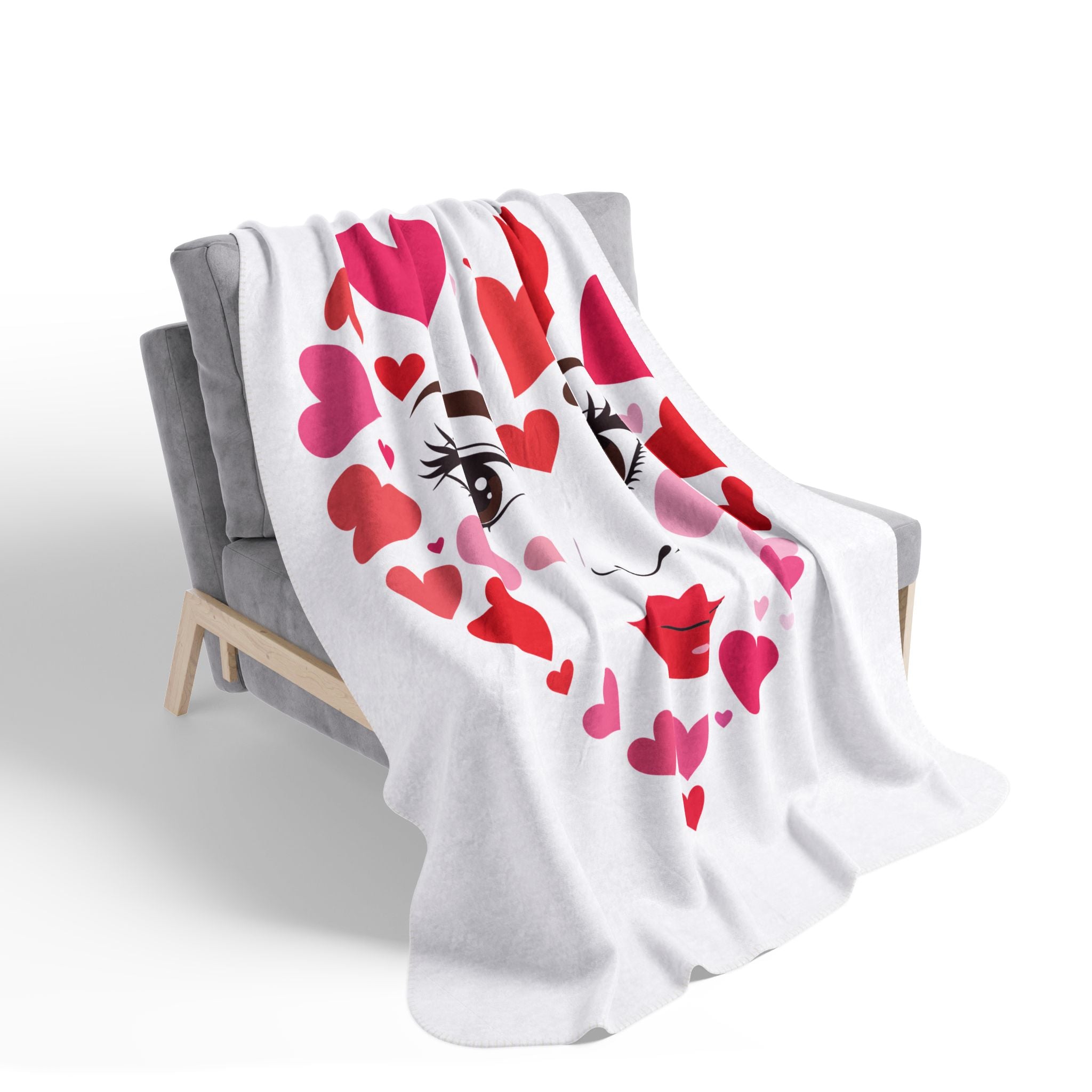 White blanket with heart and face design draped over a chair on a white background