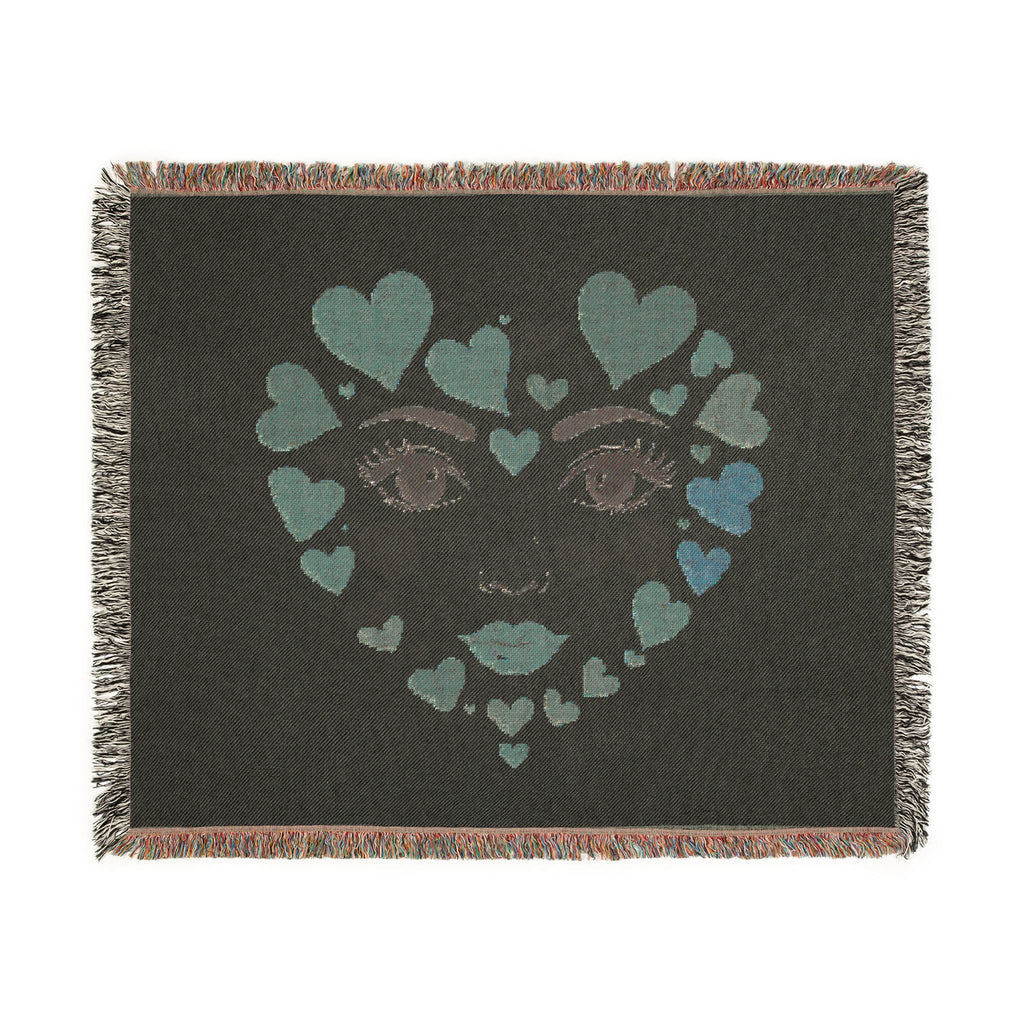 Blanket with a face design made of hearts on a black background