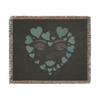 Blanket with a face design made of hearts on a black background