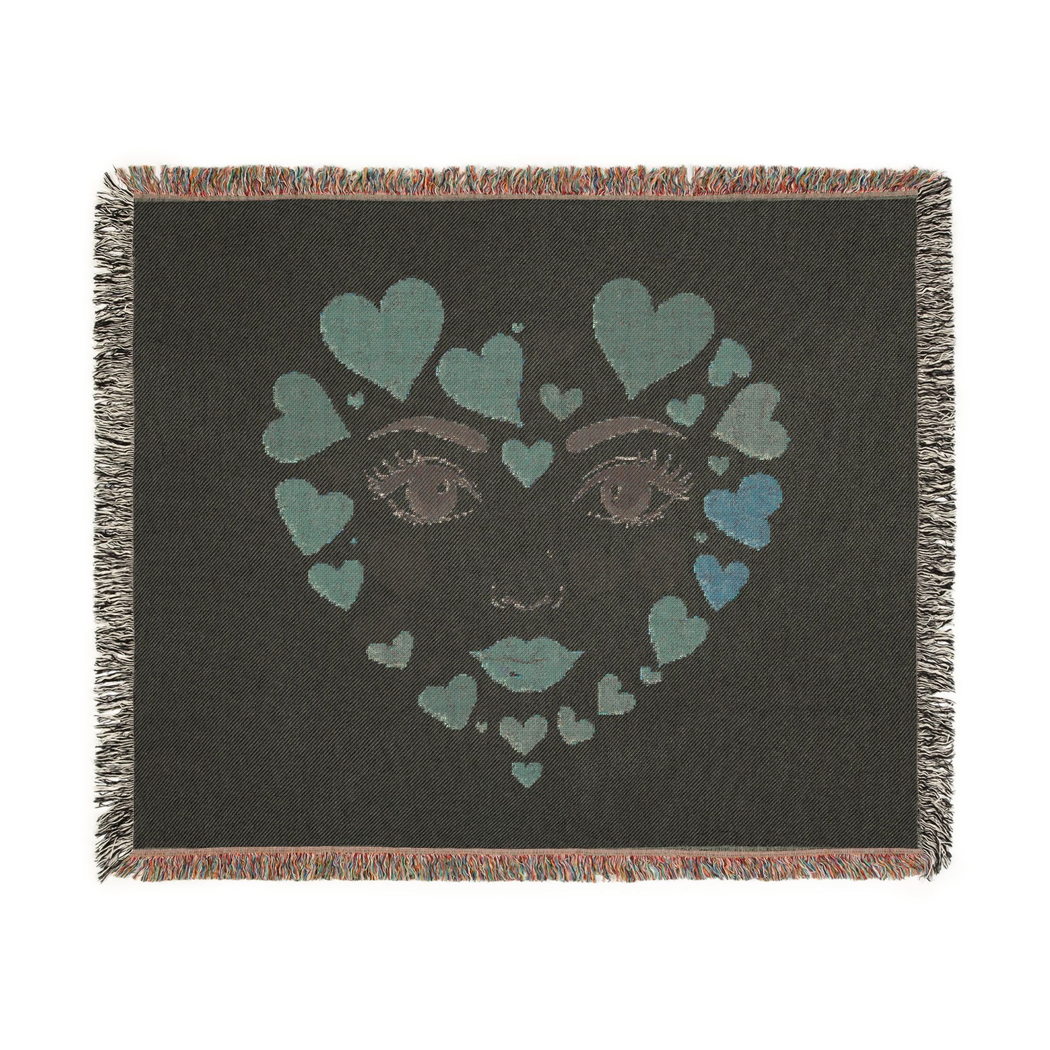 Blanket with a face design made of hearts on a black background